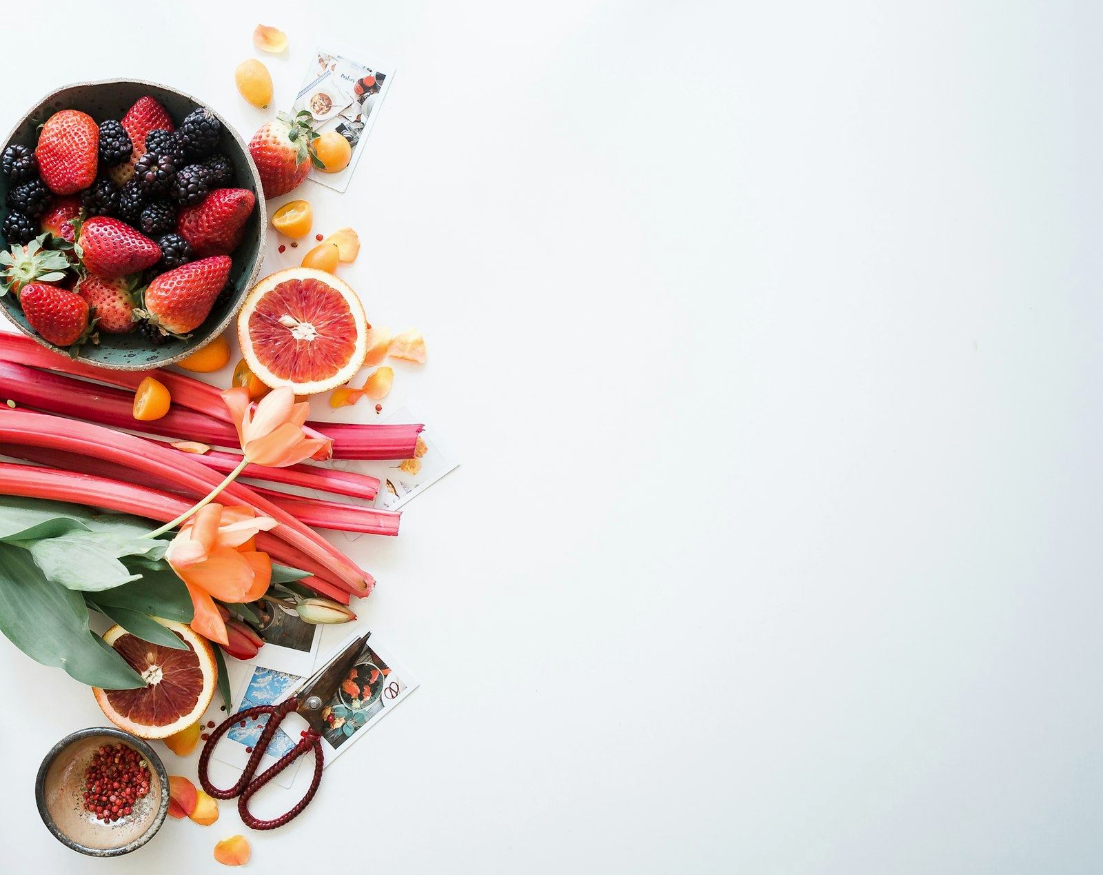 A table of vegetables, citrus and kitchen bowls