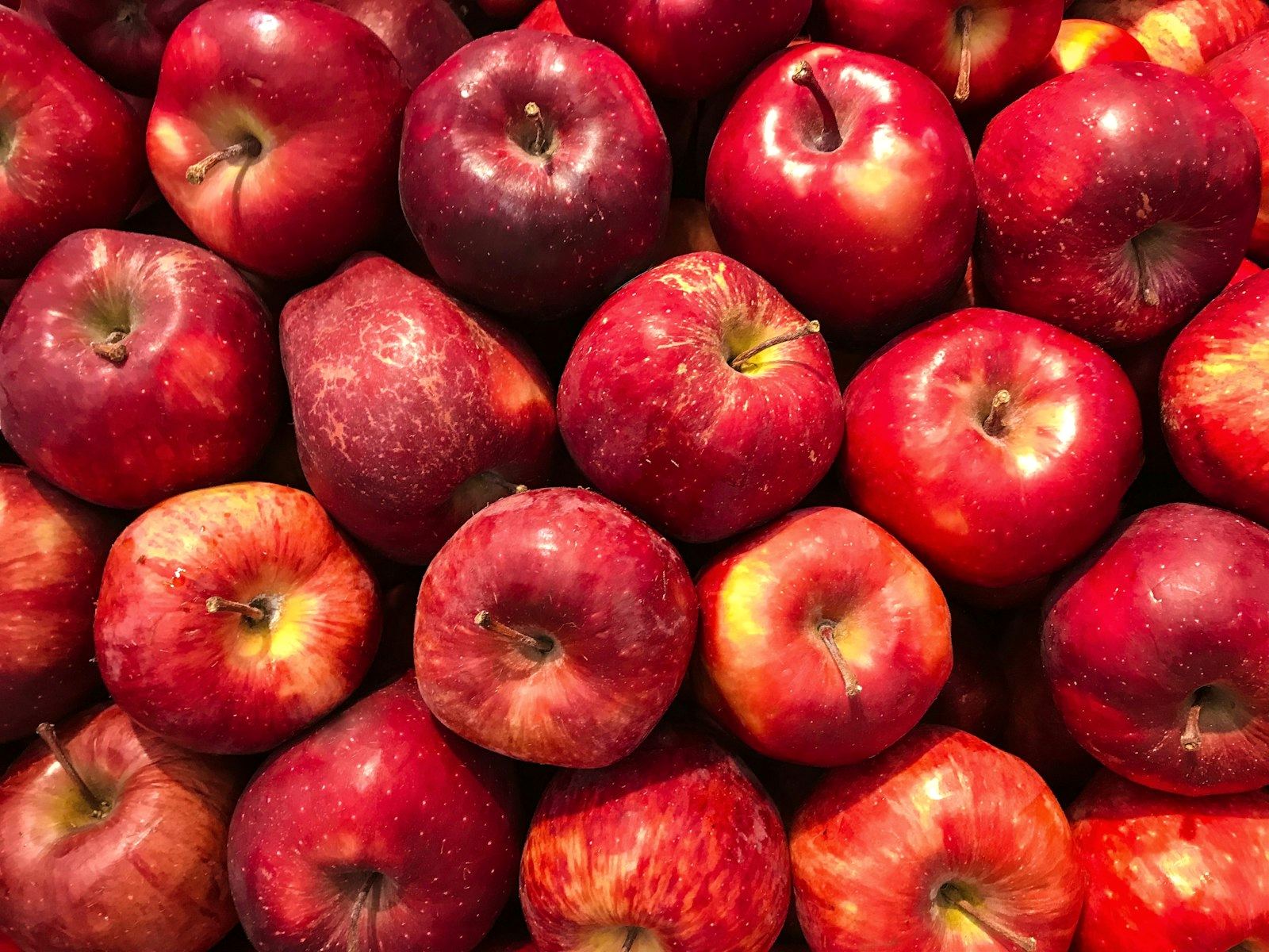 Red apples on a wooden surface
