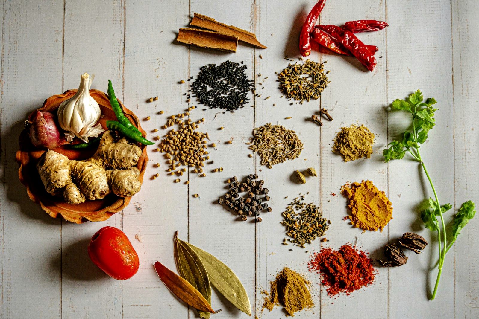 Spice jars and seeds on a wooden shelf